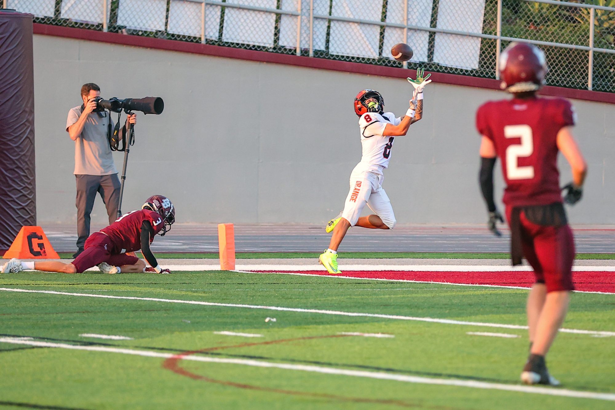 Orange Panthers receiver leaping for the ball on the sideline
