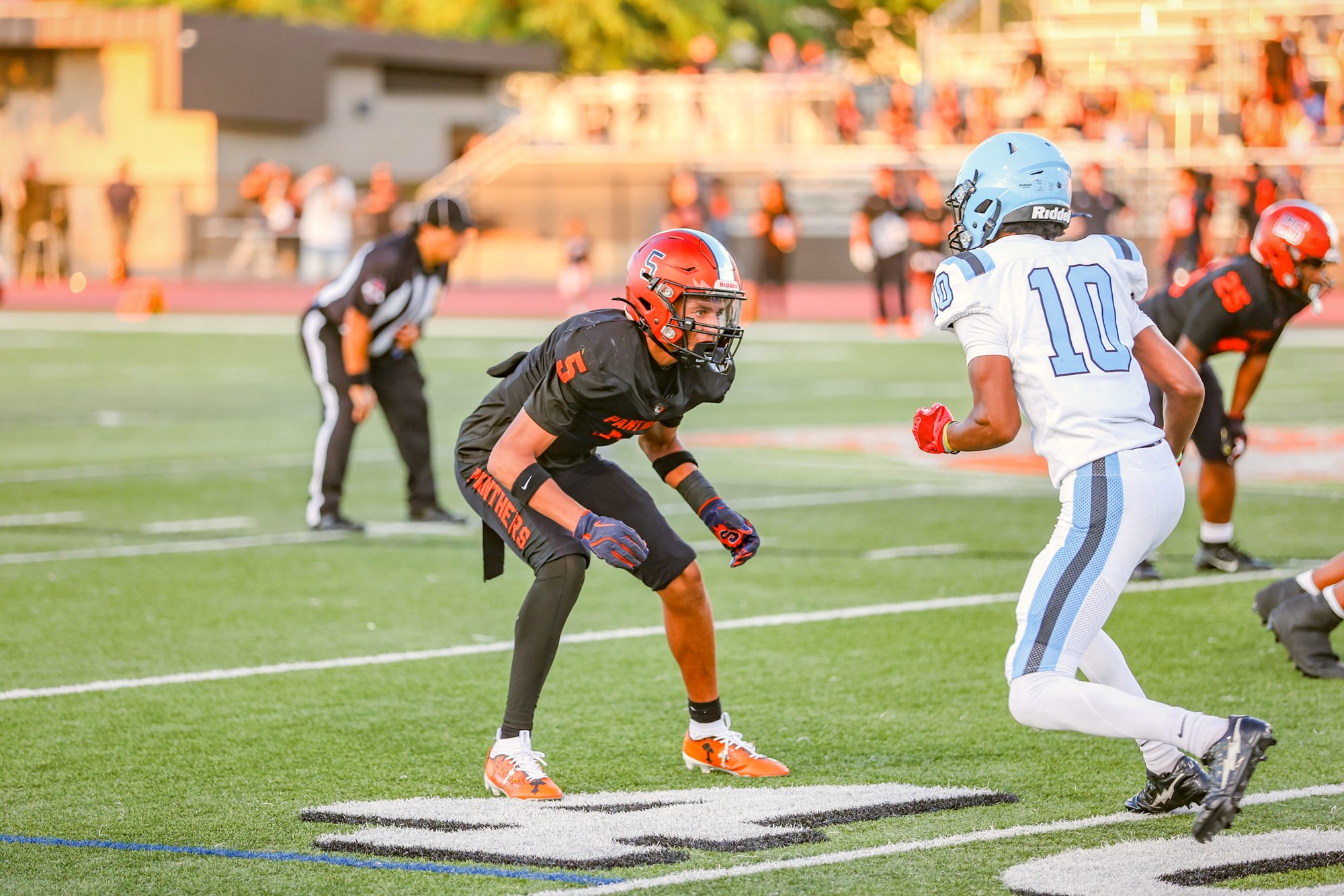 Orange Panthers #5 in his stance across from the receiver
